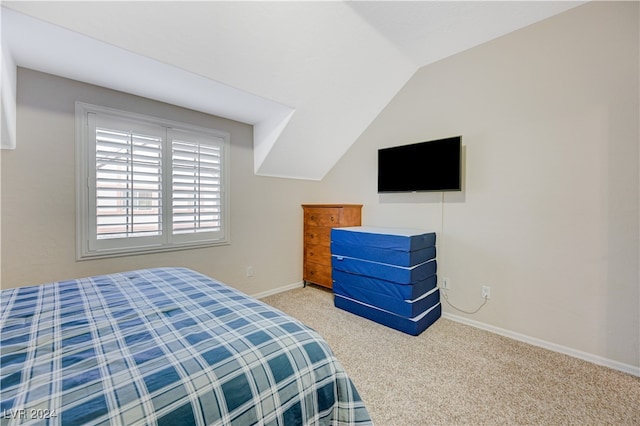 carpeted bedroom with vaulted ceiling