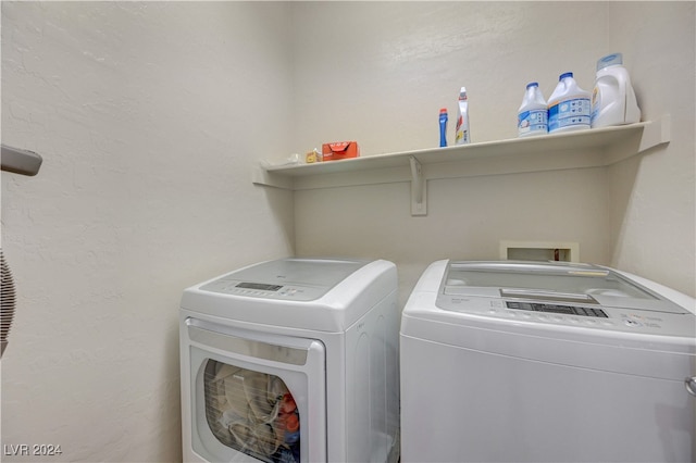 washroom with washing machine and clothes dryer