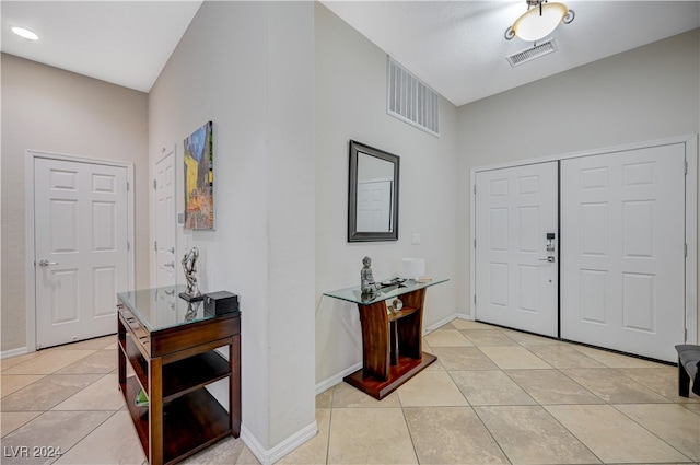 foyer entrance featuring lofted ceiling and light tile patterned floors