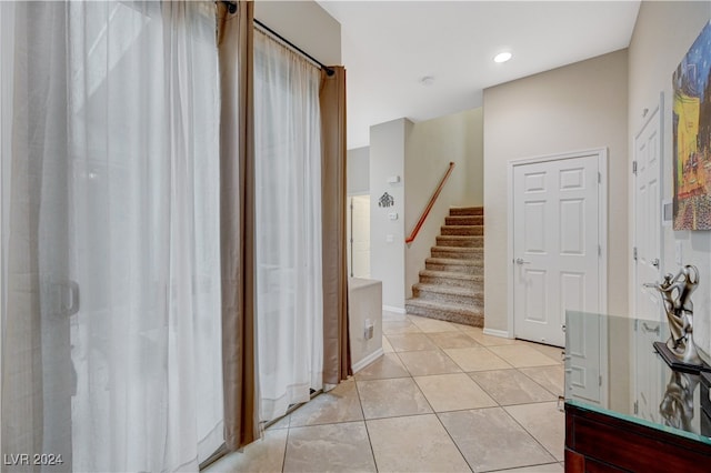 hallway featuring light tile patterned floors