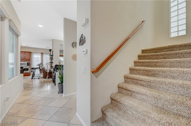 stairs featuring tile patterned floors