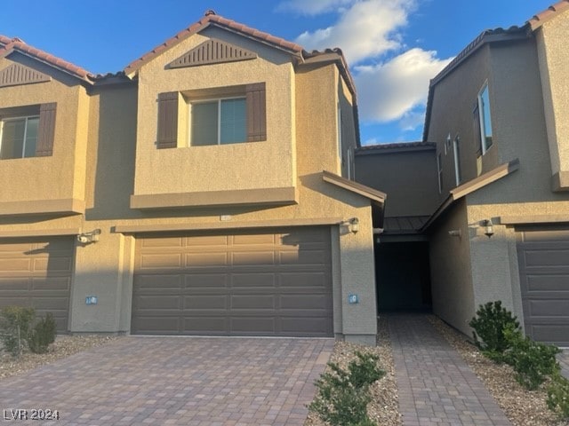 multi unit property featuring a garage