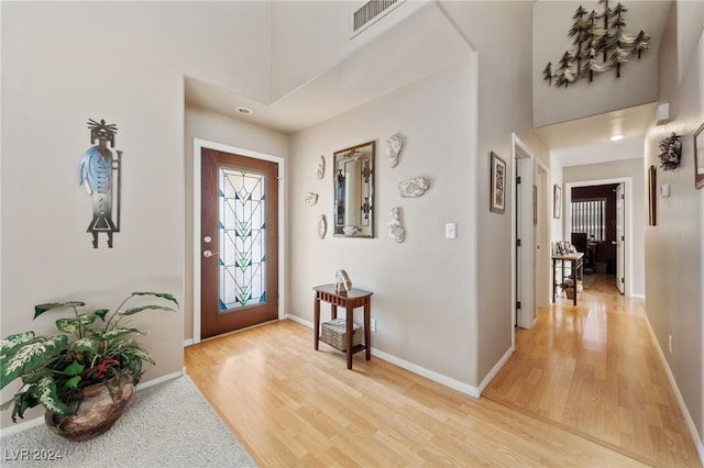 entryway with hardwood / wood-style floors