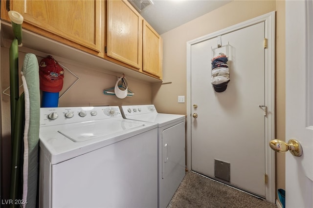 washroom with carpet flooring, separate washer and dryer, and cabinets