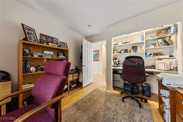 home office with light hardwood / wood-style floors