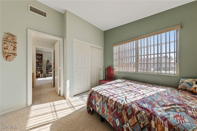 bedroom featuring a closet and light colored carpet