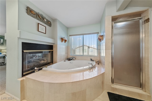 bathroom featuring plus walk in shower and tile patterned floors