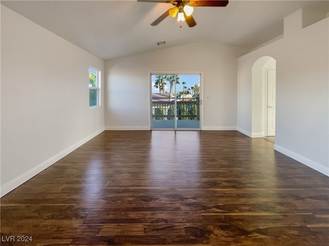 unfurnished room featuring dark hardwood / wood-style flooring, vaulted ceiling, and ceiling fan