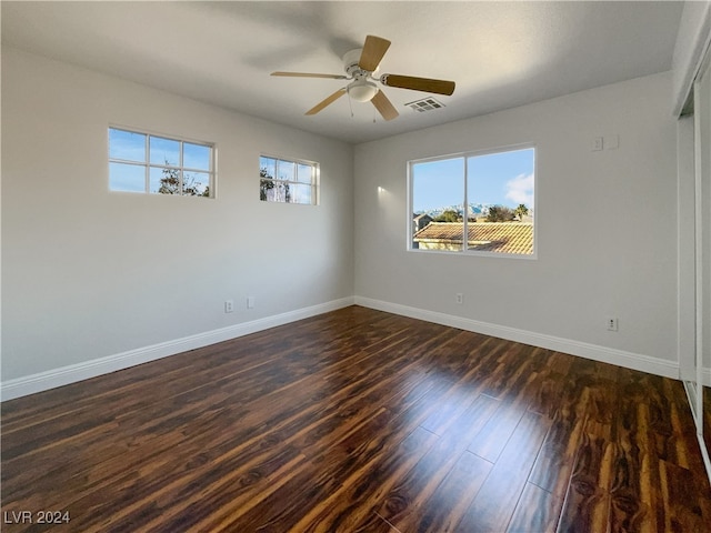 empty room featuring ceiling fan and dark hardwood / wood-style floors