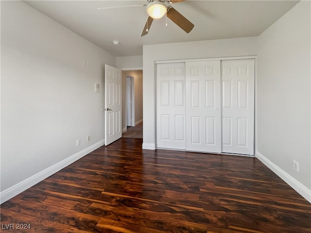 unfurnished bedroom with ceiling fan, a closet, and dark hardwood / wood-style flooring