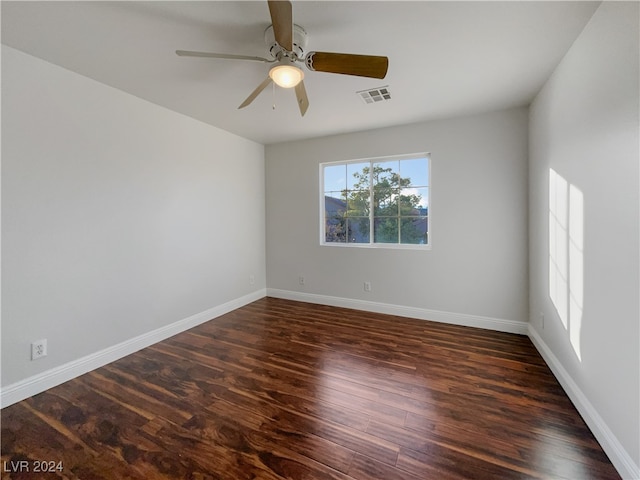 unfurnished room with ceiling fan and dark hardwood / wood-style flooring