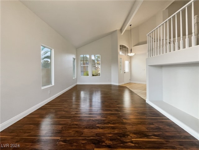 interior space with hardwood / wood-style flooring, beamed ceiling, and high vaulted ceiling