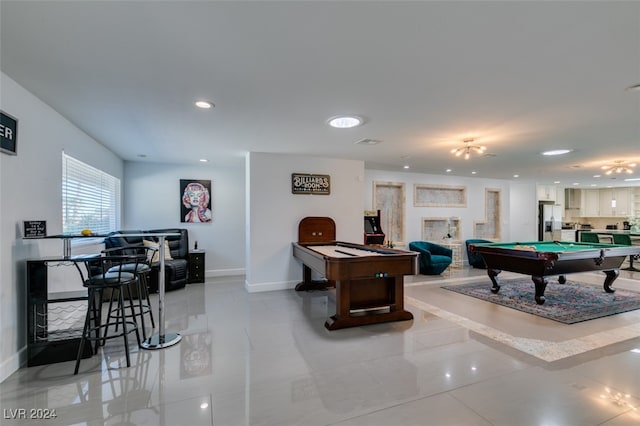 game room featuring pool table and a fireplace