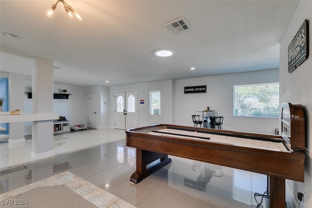 rec room featuring french doors and light tile patterned flooring