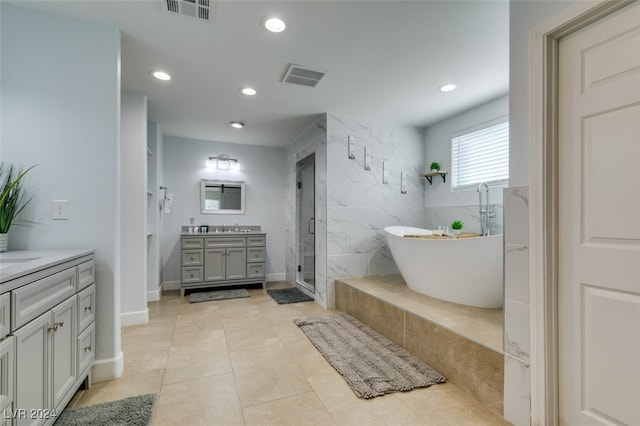 bathroom with independent shower and bath, vanity, and tile patterned floors