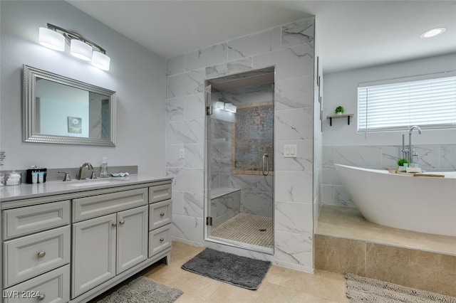 bathroom with tile patterned flooring, vanity, and independent shower and bath