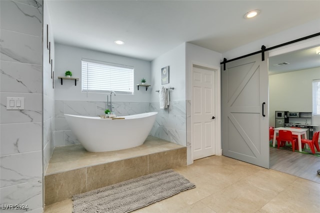 bathroom with a bathing tub and tile walls