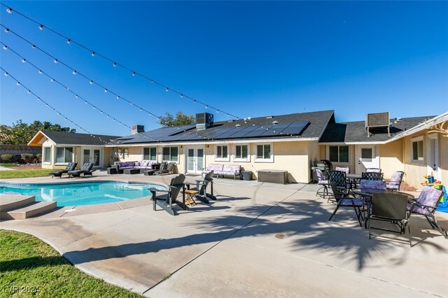 view of pool with an outdoor hangout area, a patio area, and central AC