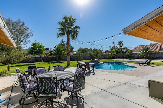 view of pool featuring a patio area and a lawn