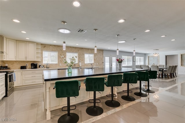 kitchen with electric stove, a large island, and plenty of natural light