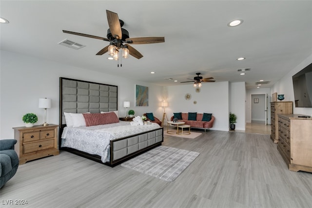 bedroom with light hardwood / wood-style floors and ceiling fan