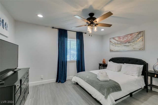 bedroom with light hardwood / wood-style floors and ceiling fan