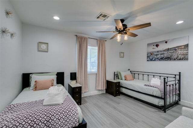 bedroom with ceiling fan and light hardwood / wood-style flooring