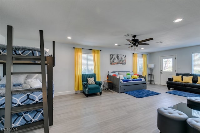 living room with ceiling fan and light hardwood / wood-style flooring