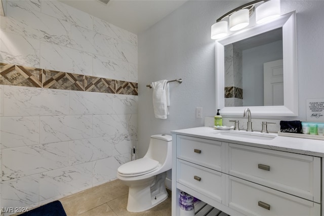 bathroom featuring vanity, tile patterned floors, and toilet