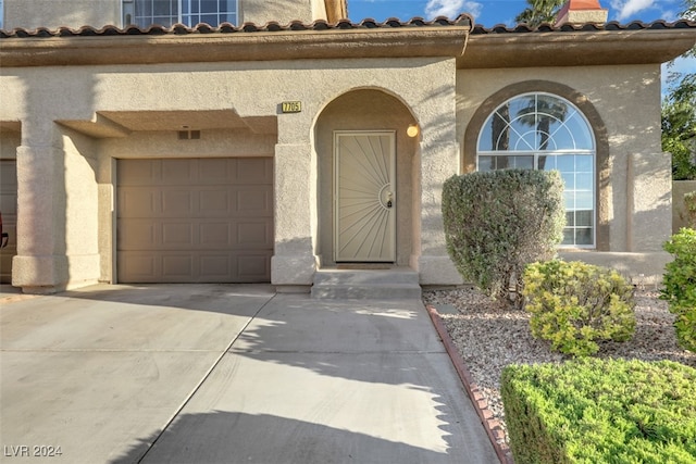 view of exterior entry with a garage