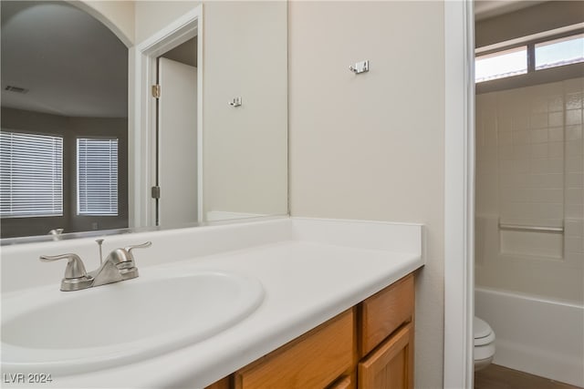 full bathroom with toilet, vanity, and  shower combination