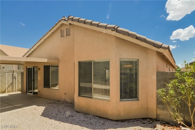 view of side of home featuring a patio area