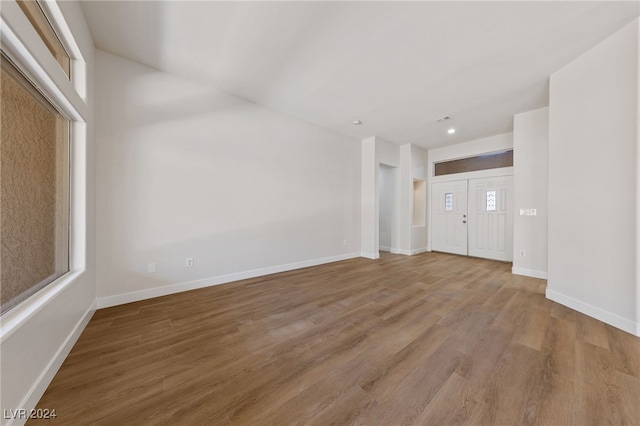 unfurnished living room with hardwood / wood-style flooring