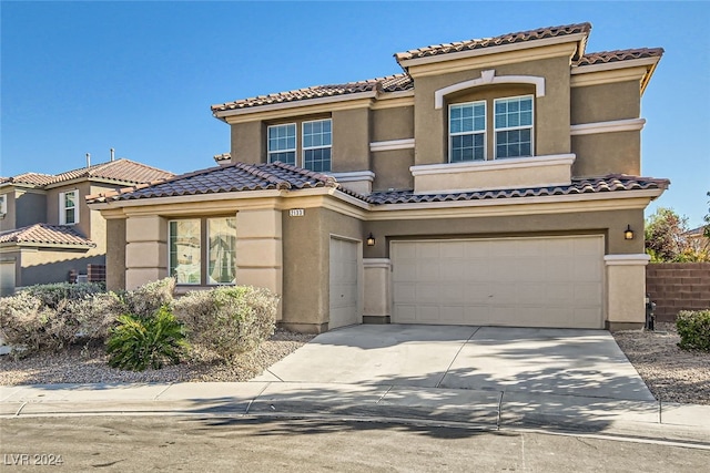 mediterranean / spanish-style home with a garage