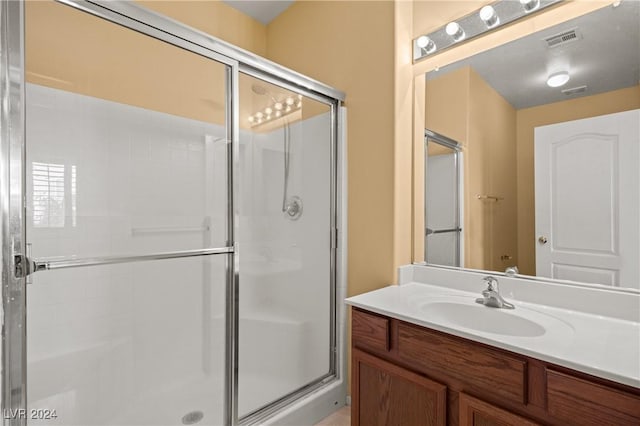 bathroom with vanity and an enclosed shower