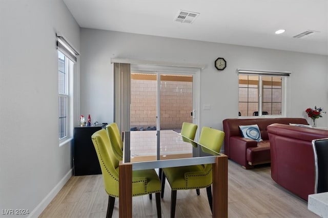 dining space with light hardwood / wood-style floors and a wealth of natural light