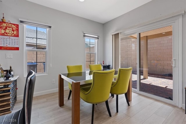 dining space with a healthy amount of sunlight and light wood-type flooring