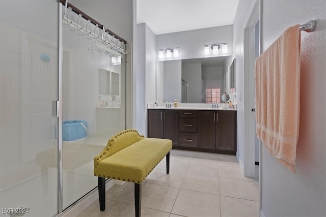 bathroom with tile patterned floors, vanity, and an enclosed shower