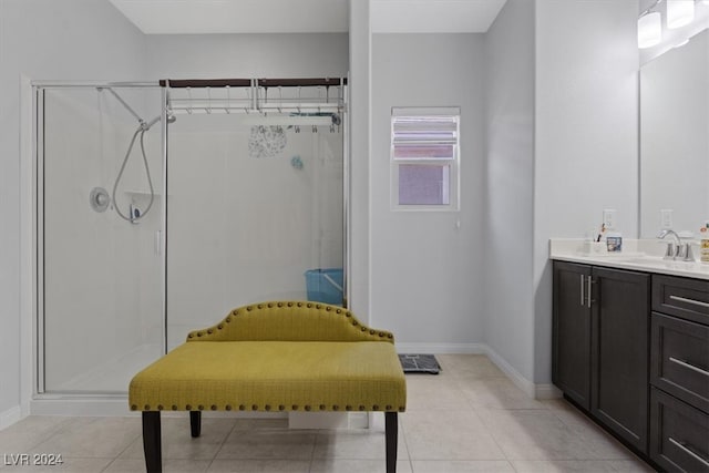 bathroom with tile patterned floors, vanity, and an enclosed shower