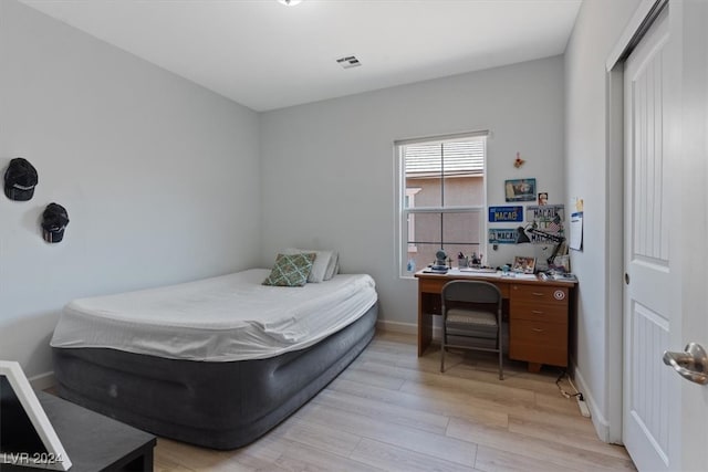 bedroom with a closet and light hardwood / wood-style flooring