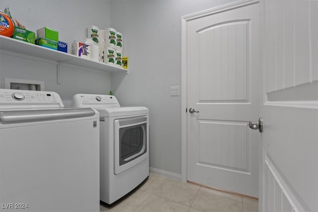 washroom featuring light tile patterned floors and washer and dryer