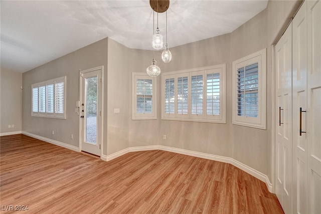 foyer entrance featuring light hardwood / wood-style floors and an inviting chandelier