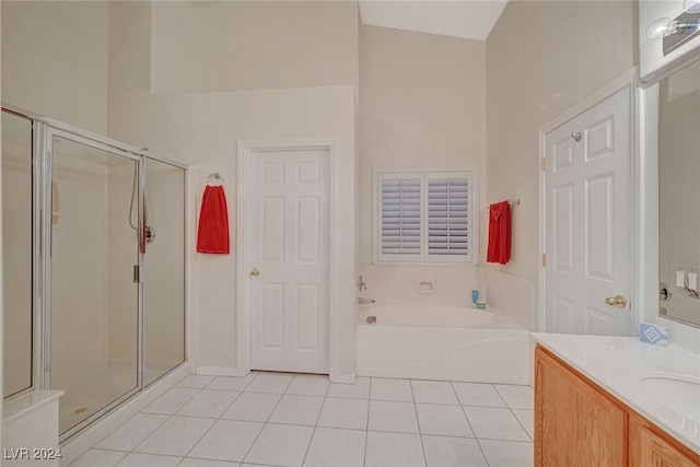 bathroom featuring tile patterned flooring, vanity, and shower with separate bathtub