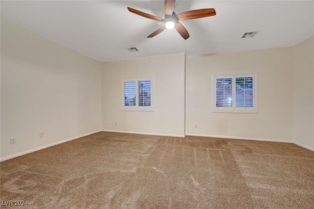 spare room featuring carpet floors and ceiling fan