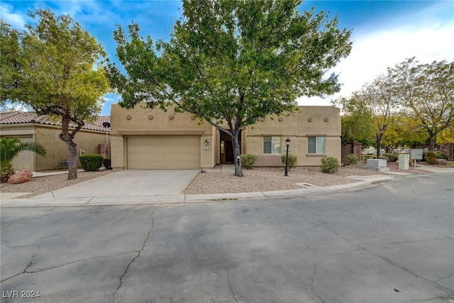 pueblo-style home featuring a garage