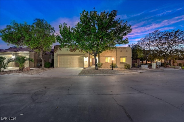 pueblo-style home with a garage