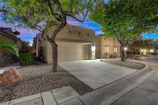 pueblo-style home with a garage