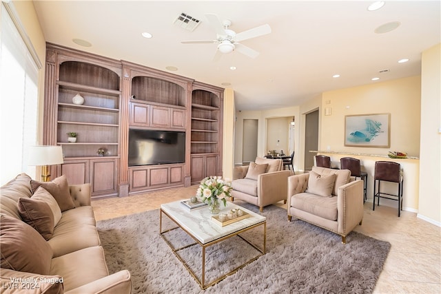 tiled living room with ceiling fan