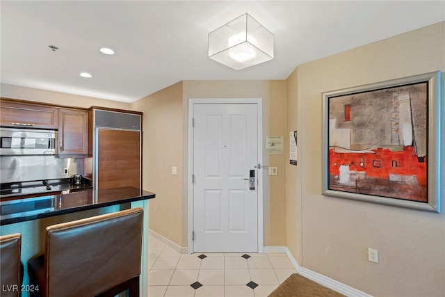 kitchen featuring built in refrigerator and light tile patterned flooring