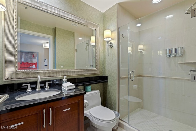 bathroom with toilet, vanity, and walk in shower